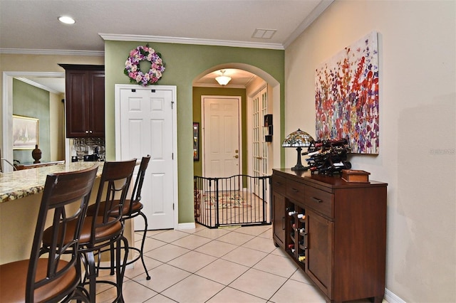 tiled entryway with crown molding