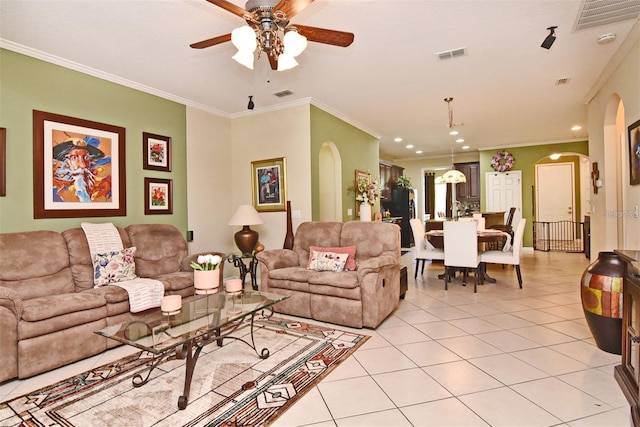 tiled living room with crown molding and ceiling fan