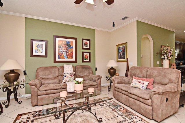 tiled living room featuring ornamental molding and ceiling fan