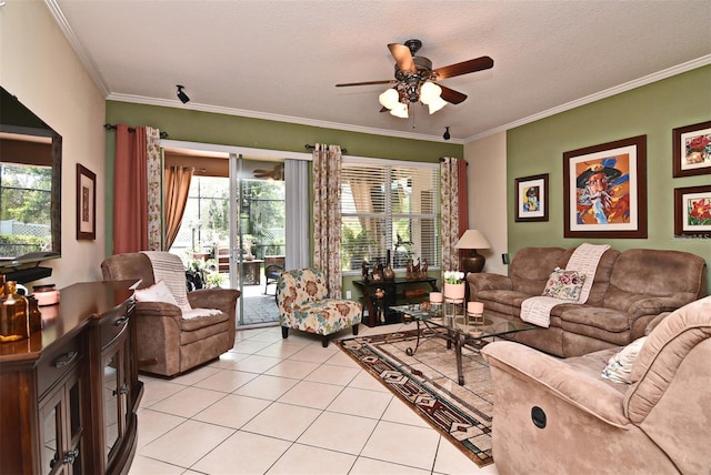 tiled living room featuring ceiling fan, ornamental molding, plenty of natural light, and a textured ceiling