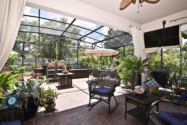 view of patio featuring a lanai and ceiling fan