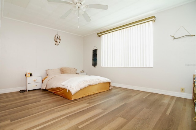 bedroom with wood finished floors and baseboards