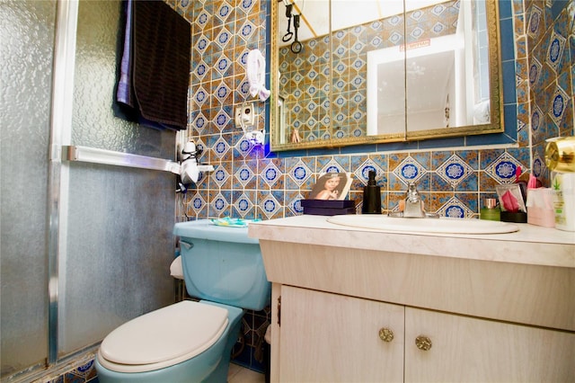 bathroom featuring a stall shower, tasteful backsplash, toilet, vanity, and tile walls