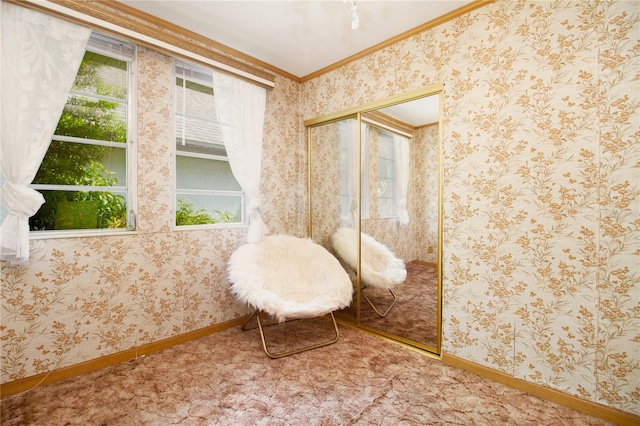 interior space featuring baseboards, ornamental molding, and wallpapered walls