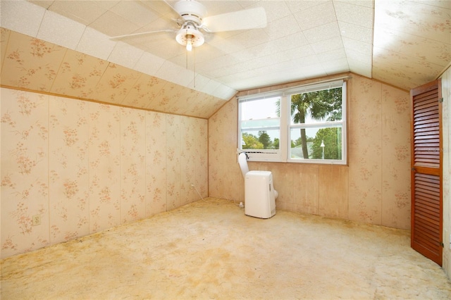 bonus room with wallpapered walls, carpet, and vaulted ceiling