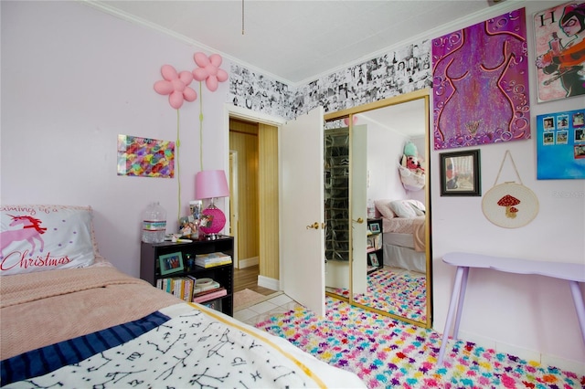 bedroom with a closet and crown molding