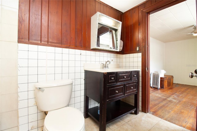 bathroom with radiator heating unit, tile patterned flooring, vanity, and toilet