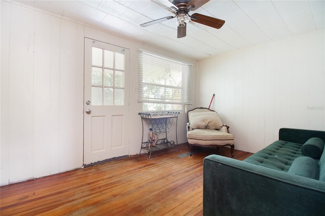 living area featuring light wood-style floors and a ceiling fan