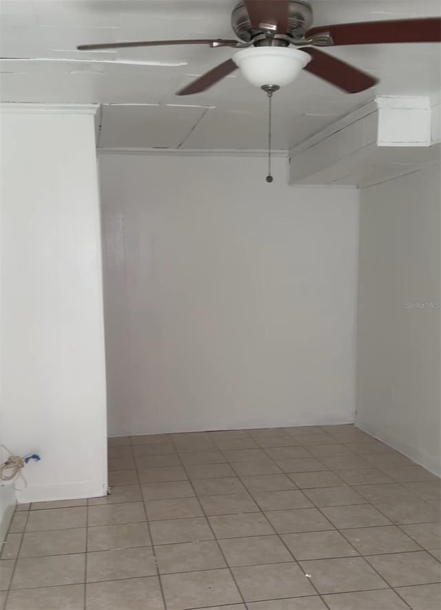 unfurnished room with light tile patterned floors and a ceiling fan