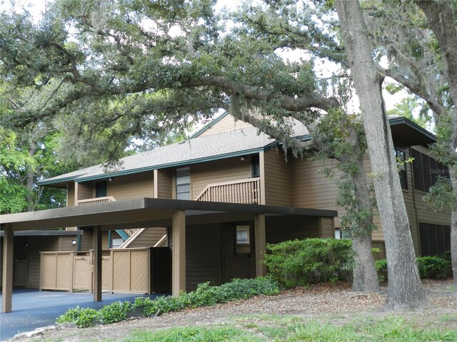 view of front of house with a balcony and a carport