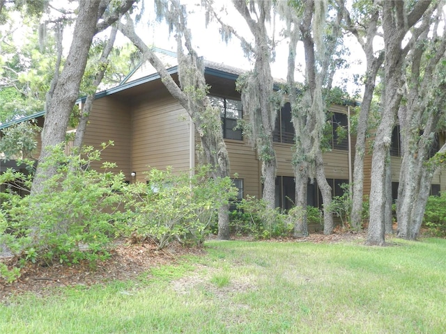 view of side of home with a yard