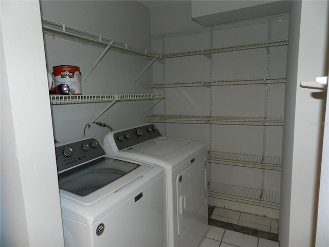 laundry room featuring washer and dryer, laundry area, and light tile patterned floors