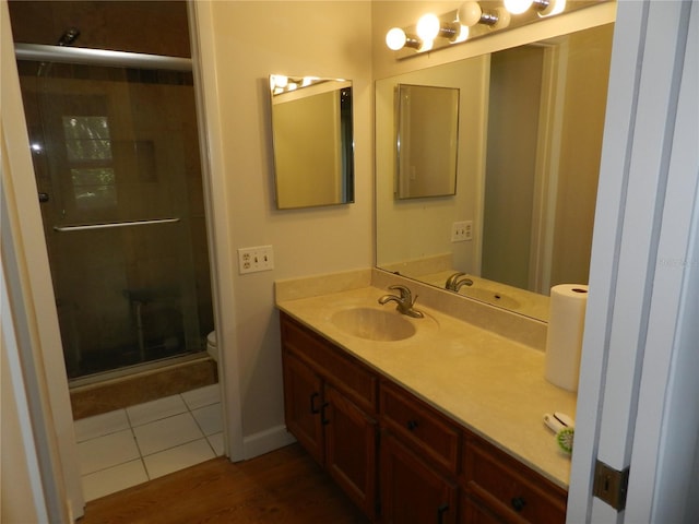 bathroom with toilet, a shower stall, and vanity