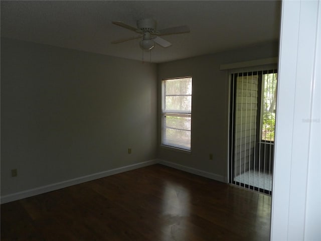 empty room featuring ceiling fan, baseboards, and wood finished floors