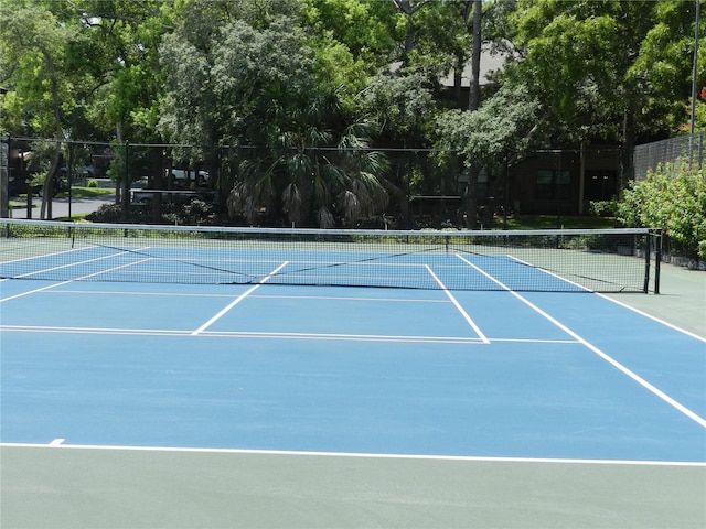 view of sport court featuring fence