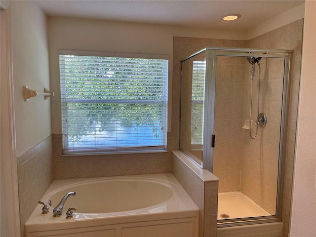 bathroom with shower with separate bathtub