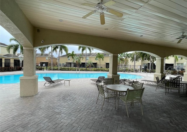 view of swimming pool with ceiling fan and a patio