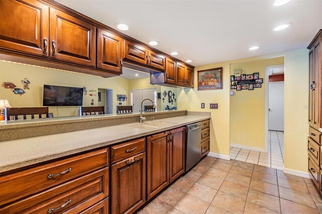 kitchen with light tile patterned flooring, sink, and stainless steel dishwasher