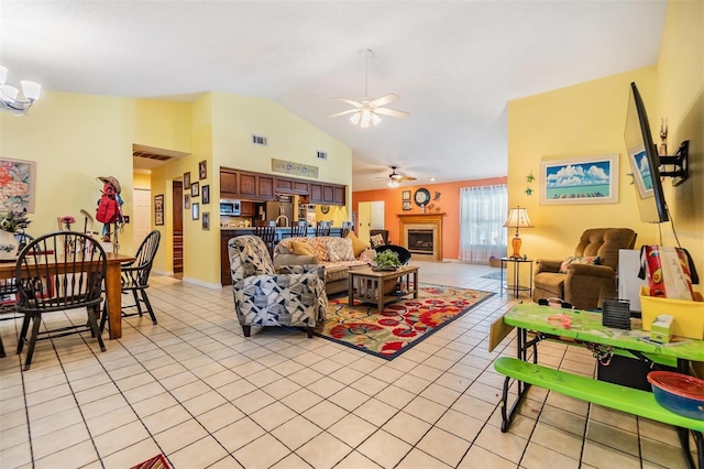 tiled living room with vaulted ceiling and ceiling fan