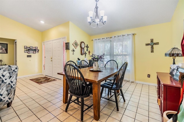 tiled dining area with an inviting chandelier