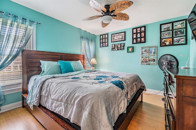 bedroom with ceiling fan and light hardwood / wood-style flooring