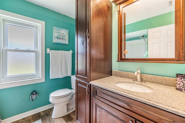 bathroom featuring vanity, toilet, and wood-type flooring