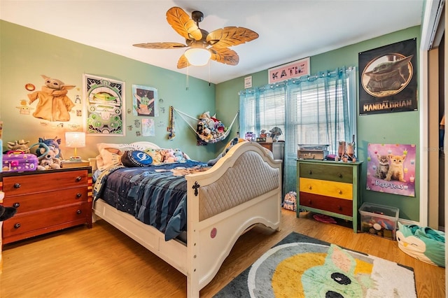 bedroom with hardwood / wood-style floors and ceiling fan