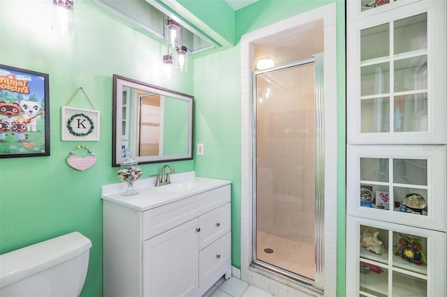 bathroom featuring a shower with door, vanity, and toilet