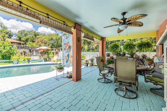 view of patio with ceiling fan and a fenced in pool