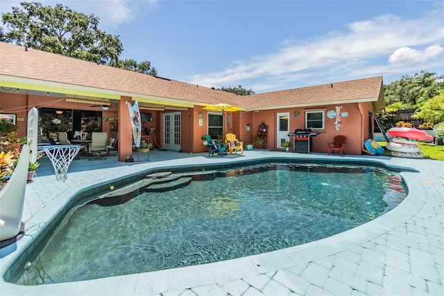 view of pool with a patio and ceiling fan