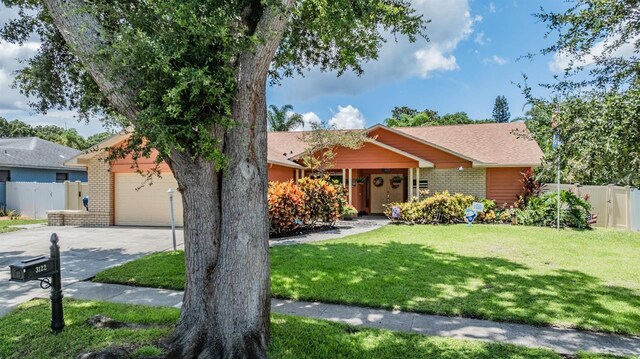 view of front of property with a garage and a front lawn