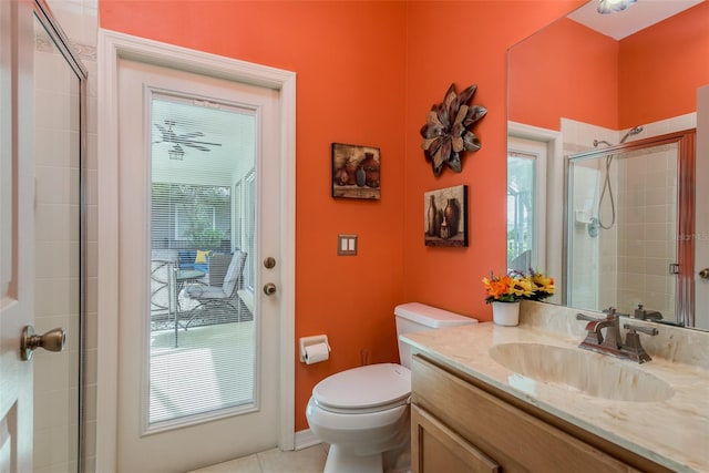 bathroom featuring a shower with door, a wealth of natural light, and toilet