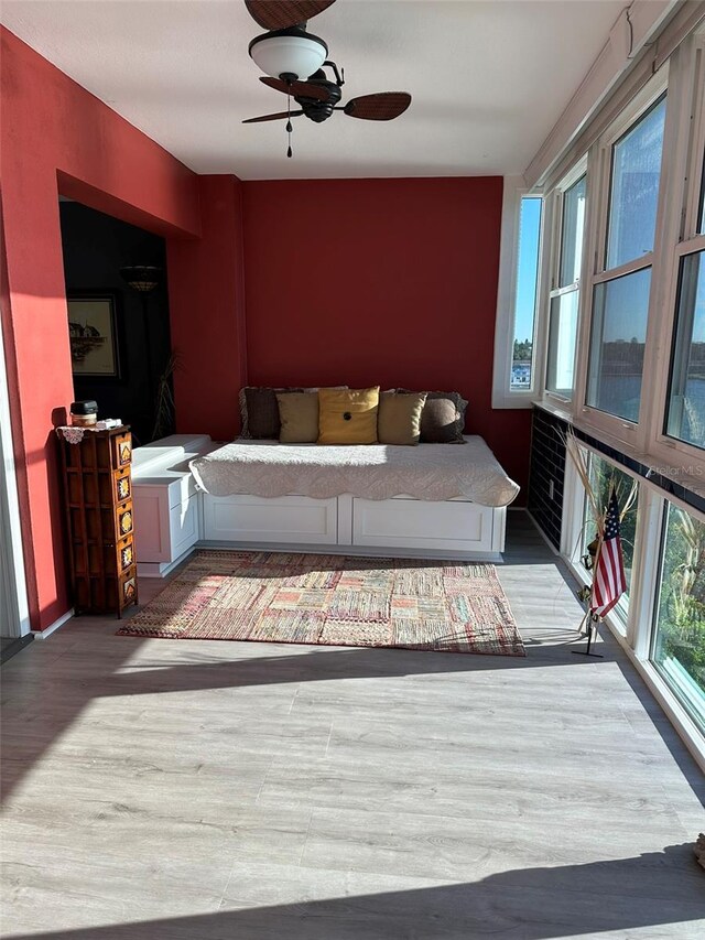 living room with hardwood / wood-style flooring and ceiling fan