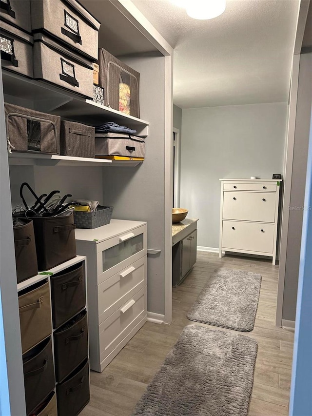 walk in closet featuring light wood-type flooring