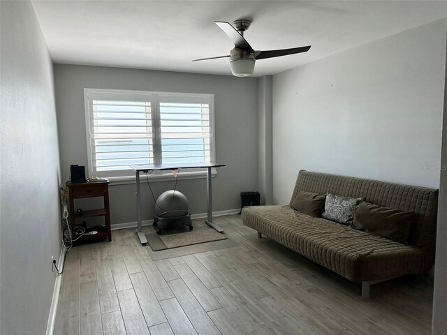 sitting room with light hardwood / wood-style floors and ceiling fan