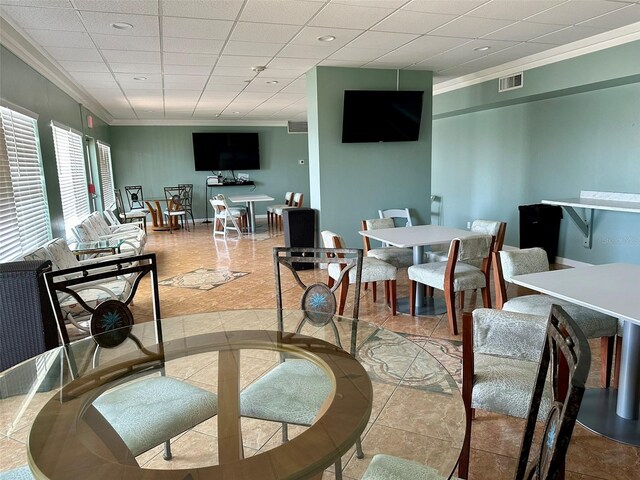 dining room with light tile patterned floors and ornamental molding