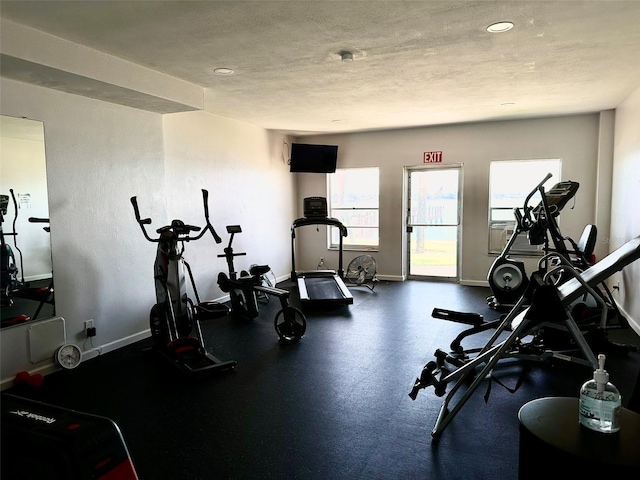 gym featuring a textured ceiling