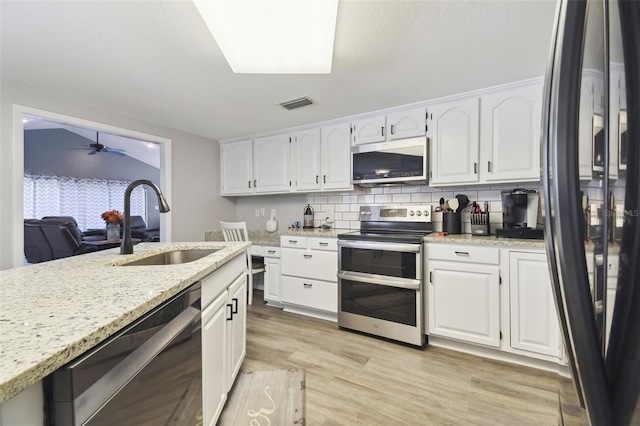 kitchen featuring ceiling fan, sink, white cabinetry, and stainless steel appliances