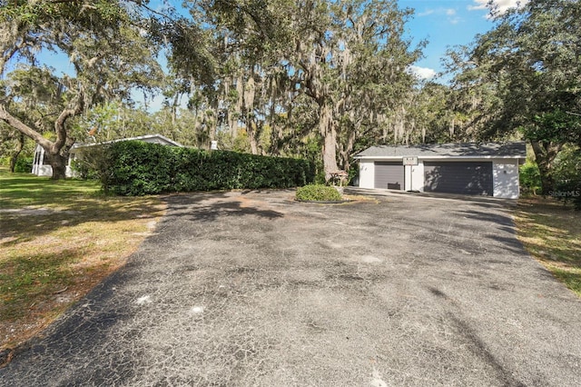 exterior space featuring a garage and an outdoor structure