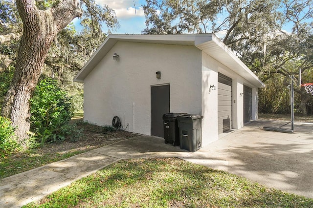 view of side of home featuring an outbuilding and a garage