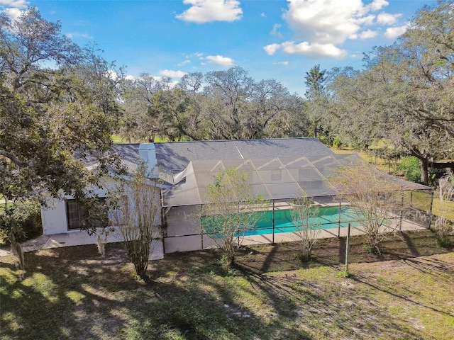 view of pool featuring a lawn, a lanai, and a patio