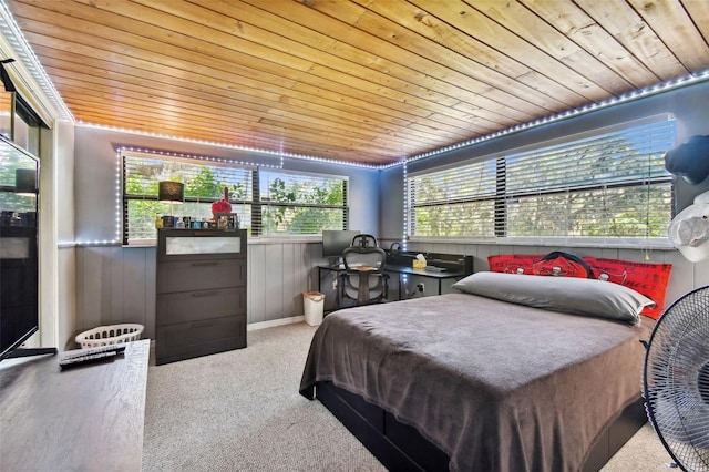 carpeted bedroom with wooden walls and wooden ceiling