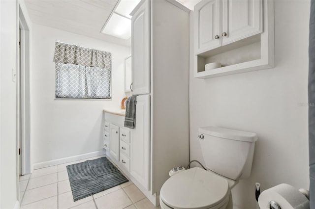 bathroom featuring tile patterned flooring, vanity, and toilet