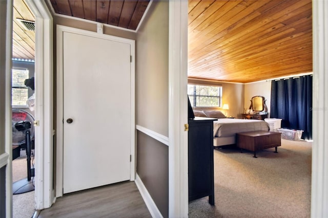 bedroom with hardwood / wood-style floors, ornamental molding, and wood ceiling