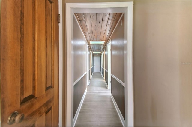 hall featuring hardwood / wood-style floors and wooden ceiling