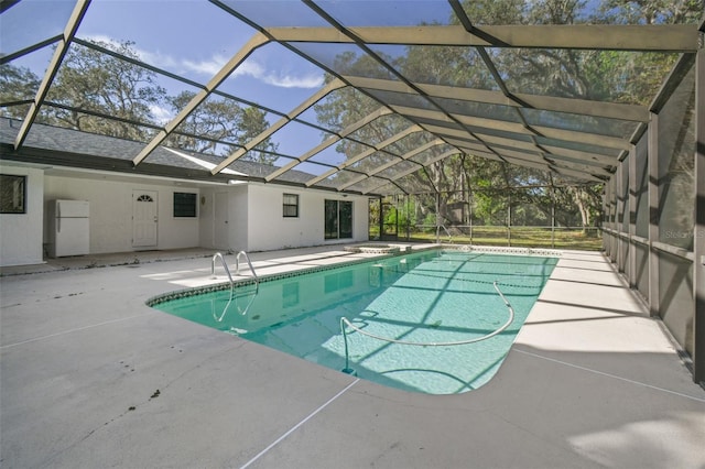 view of pool with a patio and a lanai