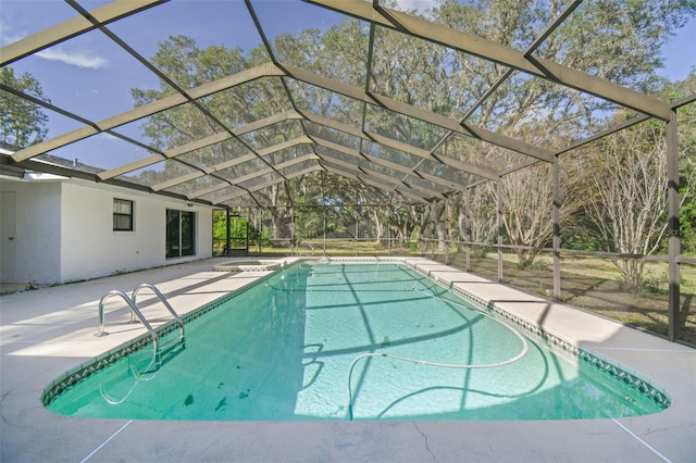 view of pool featuring glass enclosure and a patio area