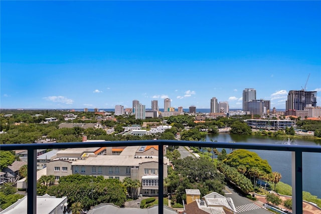balcony featuring a water view and a city view