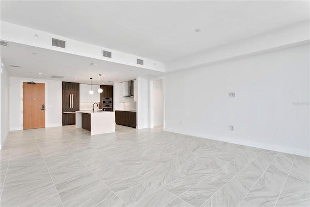 unfurnished living room with sink