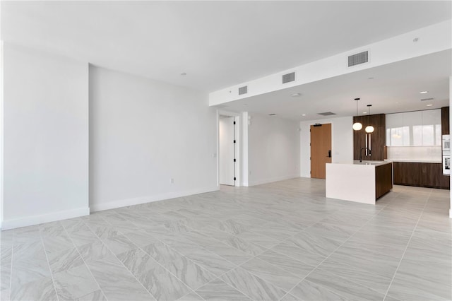 unfurnished living room with sink